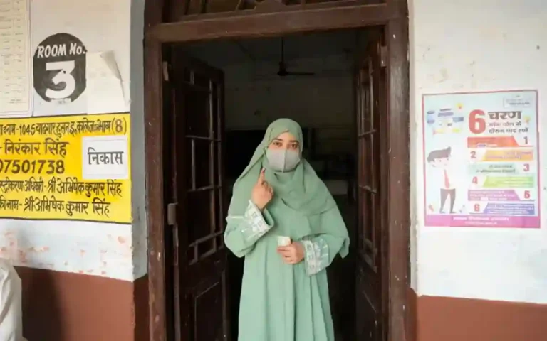 RisingCumilla.Com - A Muslim voter shows her index finger marked with an indelible ink after casting her vote